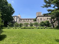 Side view of the Met Cloisters museum with historic architecture surrounded by greenery