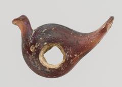 Glass pendant shaped like a bird with transparent and colored details