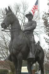 Statue of President Theodore Roosevelt in his Rough Rider uniform riding a horse