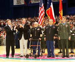 Secretary of Defense William S. Cohen and San Antonio Spurs Chairman Peter Holt honoring Medal of Honor recipients Jose M. Lopez, Lucien Adams, and Richard Rocco at halftime of a basketball game in San Antonio