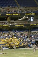 Special forces soldier rappelling from Alamodome rafters before U.S. Army-sponsored All-American Bowl football game in San Antonio Texas