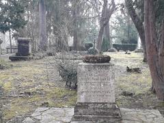 Tombstone of Eduard Scheidemantel with intricate stone carvings and a cross