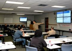 Navy Reserve Cmdr. Matthew Lee speaking at 2009 Mid-Atlantic Joint Services Immigration and Naturalization Symposium aboard Naval Station Norfolk