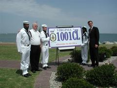 Virginia Governor Mark Warner with Navy Honor Guard and family of USS Cole sailor at Norfolk Naval Station commemorative license plate event