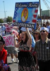 Friends and family cheering for the return of the guided-missile destroyer USS Cole at Naval Station Norfolk