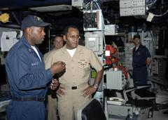 Operations Specialist 1st Class Tyrone Barlow briefing Vice Adm. Mel G. Williams Jr. on combat information center capabilities aboard USS Cole