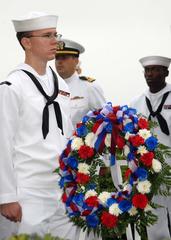 Gas Turbine Systems Technician 3rd Class Corey Callies presents wreath at USS Cole Memorial ceremony at Naval Station Norfolk