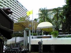 Oriental Hotel Pier with wooden walkway and lampposts at sunset
