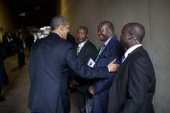 President Barack Obama greeting South African security personnel at Nelson Mandela memorial service