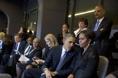 President Obama talks with First Lady Michelle Obama and world leaders at FNB Stadium