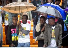 South Africans listening to President Obama's remarks at Nelson Mandela memorial service