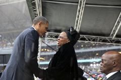 President Obama greeting Graca Machel after memorial service speech