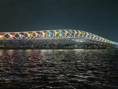 Sabarmati riverfront and Atal Pedestrian Bridge illuminated at night with colorful lighting