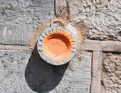 Nivellement benchmark plate on the library wall in Valenciennes at 24 meters altitude