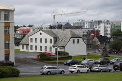 Old traditional house in downtown Reykjavík with colorful walls and a vibrant urban background