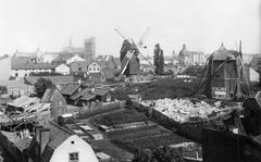 Historical view of Barnhuskvarnarna mills in Tegnérlunden with construction of Johannes Church in background, 1890