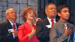 Noblesville High School junior class president Salil Gupta, Congresswoman Susan W. Brooks, Senator Luke Kenley, and Mayor John Ditslear standing for the national anthem at annual Veterans Day program