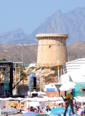 Medieval Torre de la Illeta de l'Horta lighthouse tower at El Campello beach in Alicante Spain