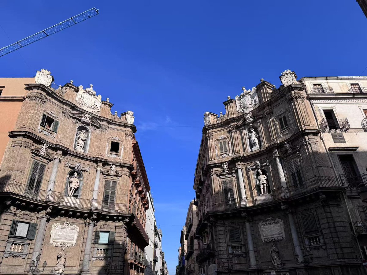 Quattro Canti Square in Palermo showing historic Italian buildings under blue sky