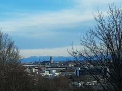 View south from Olympiapark in Munich showing Frauenkirche and the Alps