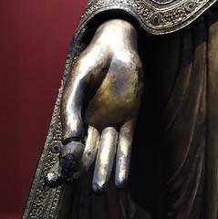 Close-up of a standing Buddha statue hand holding a myrobalan fruit at the Chester Beatty Library, Dublin
