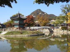 Gyeongbok Palace lake with vibrant fall foliage in Seoul