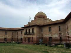 Front view of Jaipur House in Delhi with distinctive colonial architecture and green lawns