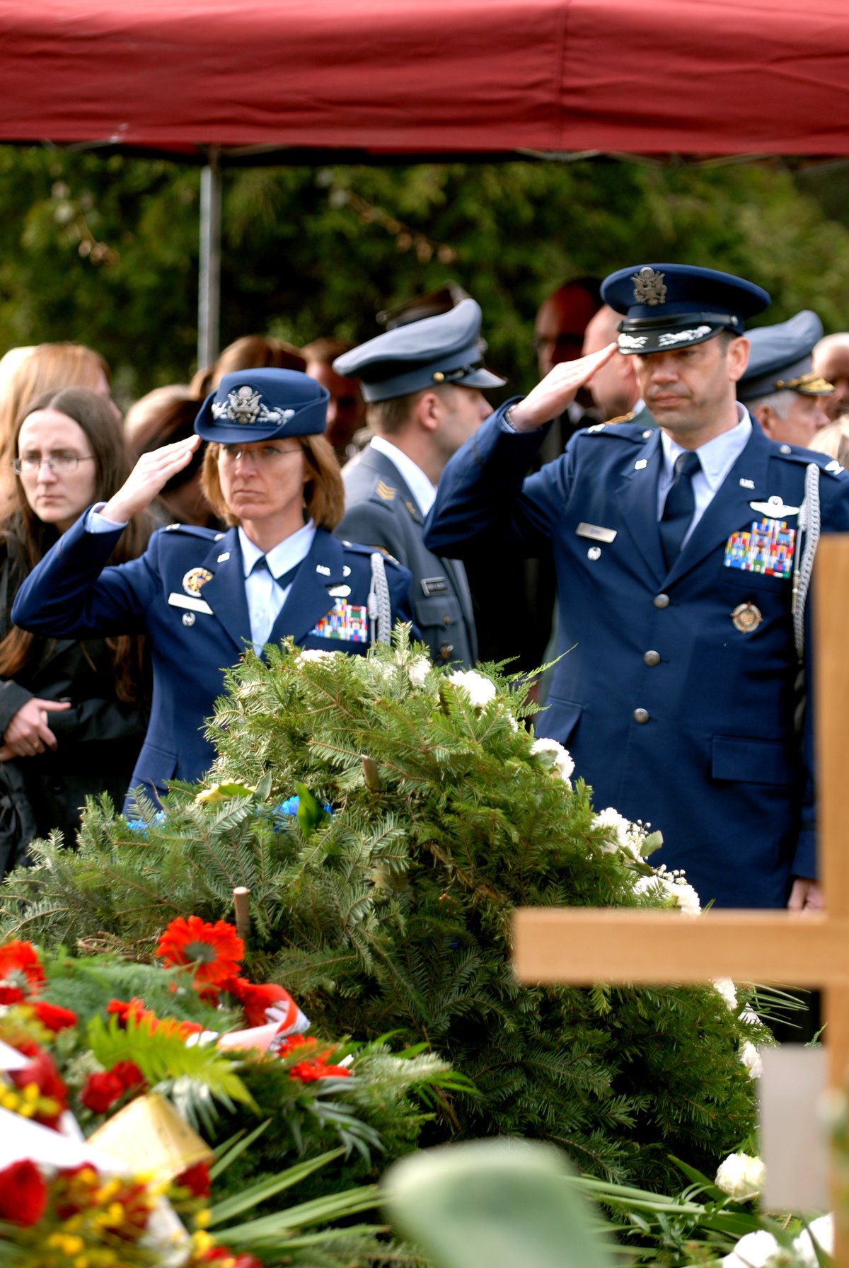 U.S. Air Force Colonels Tim Burke and Mary Peterson saluting at General Franciszek Gangor's funeral in Warsaw