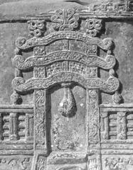 Jain Torana on an Ayagapata at Kankali Tila, carved stone panel from 75-100 CE, showcasing early Kusana period sculptural style with grapevine border and flying figures