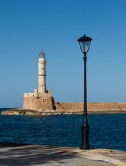 Chania lighthouse and lamp post in Crete Greece at sunset