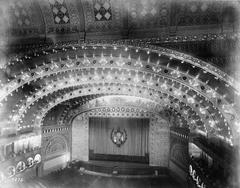 Interior view of the Auditorium Building in Chicago showing seating and stage with electric lights