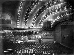 Interior view of a historic auditorium theatre with ornate balconies and a grand stage