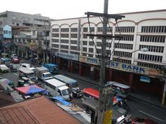 Arnaiz Avenue at the intersection of Libertad Road and Pasay Road in Pasay City with vehicles and buildings including Victory Mall and Holy Trinity Parish Church