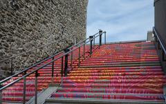 Spiral staircase at the Musée de la civilisation in Québec, featuring intricate metalwork and stone walls