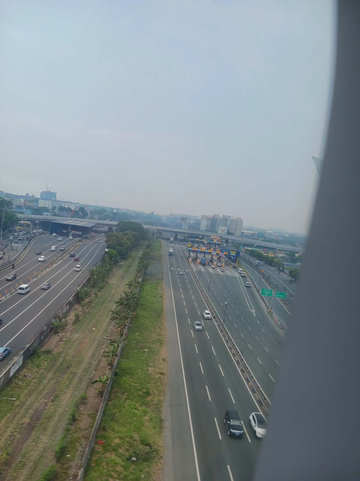 Aerial daytime view looking SSE at Nichols Toll Plaza, South Luzon Expressway and Metro Manila Skyway in Pasay, National Capital Region, Philippines