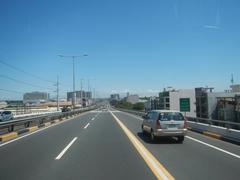 View from bus on South Luzon Expressway ascending Metro Manila Skyway around Makati City showing elevated highway and urban buildings
