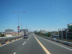 View from a bus at the front seat looking over South Luzon Expressway and Metro Manila Skyway in Makati City, Philippines