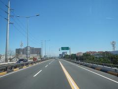 Aerial view of South Luzon Expressway and Metro Manila Skyway elevated highway in Makati City, Philippines, with cityscape and traffic below