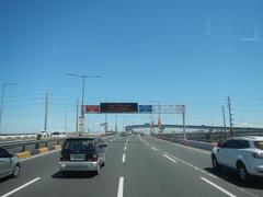 South Luzon Expressway and Metro Manila Skyway interchange in Makati City with multiple lanes and road signs under a blue sky