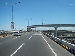 South Luzon Expressway and Metro Manila Skyway traffic in Makati City under cloudy sky