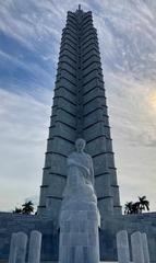 Memorial José Martí in Havana, Cuba, monument with tall stone column and sculptures under blue sky