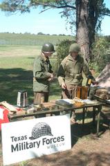 Texas Military Forces members demonstrating historic military practices at Oktoberfest Camp Swift