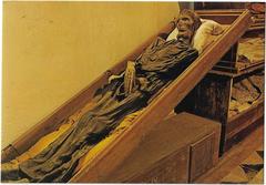 Postcard of an unusually proportioned mummified body in the Catacombs of the Capuchins, Palermo