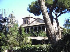 Loggiato and bell tower of San Saba church emerging from the enclosing wall in Rome