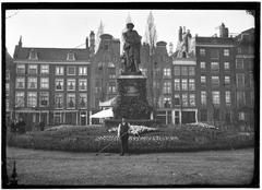 Statue of Rembrandt at Rembrandtplein with historic buildings in the background
