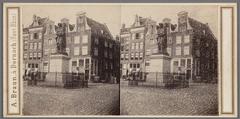 Historical statue of Rembrandt at Botermarkt (Rembrandtplein) in Amsterdam with surrounding buildings and entrance to Reguliersdwarsstraat
