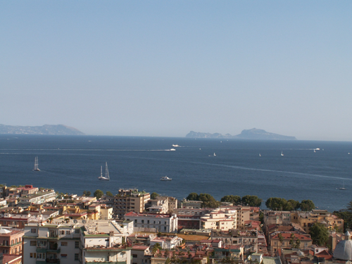 Scenic view of the island of Capri from the sea with clear blue waters and rocky coastline