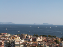 Scenic view of the island of Capri from the sea with clear blue waters and rocky coastline