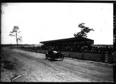 1920 Cyclecar race at Circuit de la Sarthe with Noël sur Noël speeding past grandstands