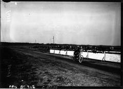 Historic motorcycle race at Circuit de la Sarthe with Alexander on Douglas speeding in front of grandstands